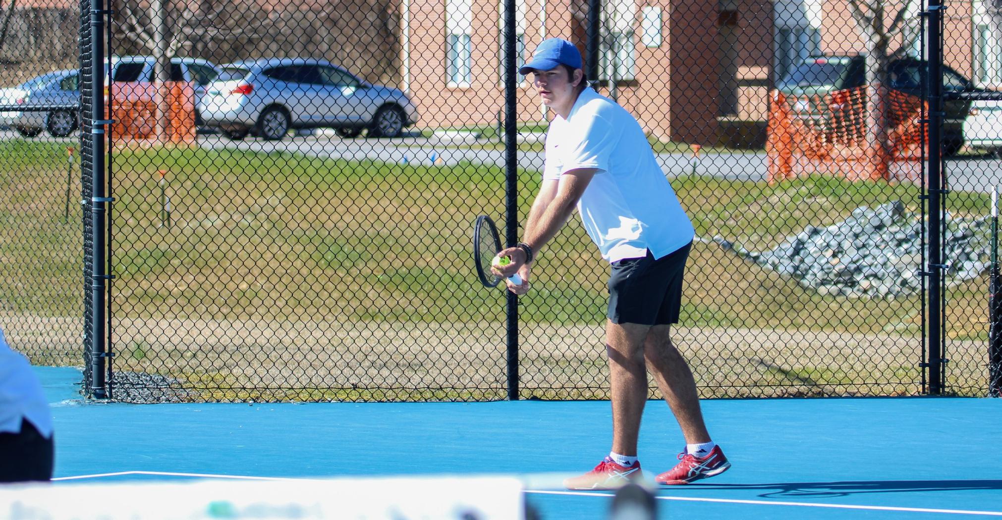 Andrew Ingram prepares to serve at the McCoy Tennis Complex (Photo courtesy of Brianna Rodibaugh '24).