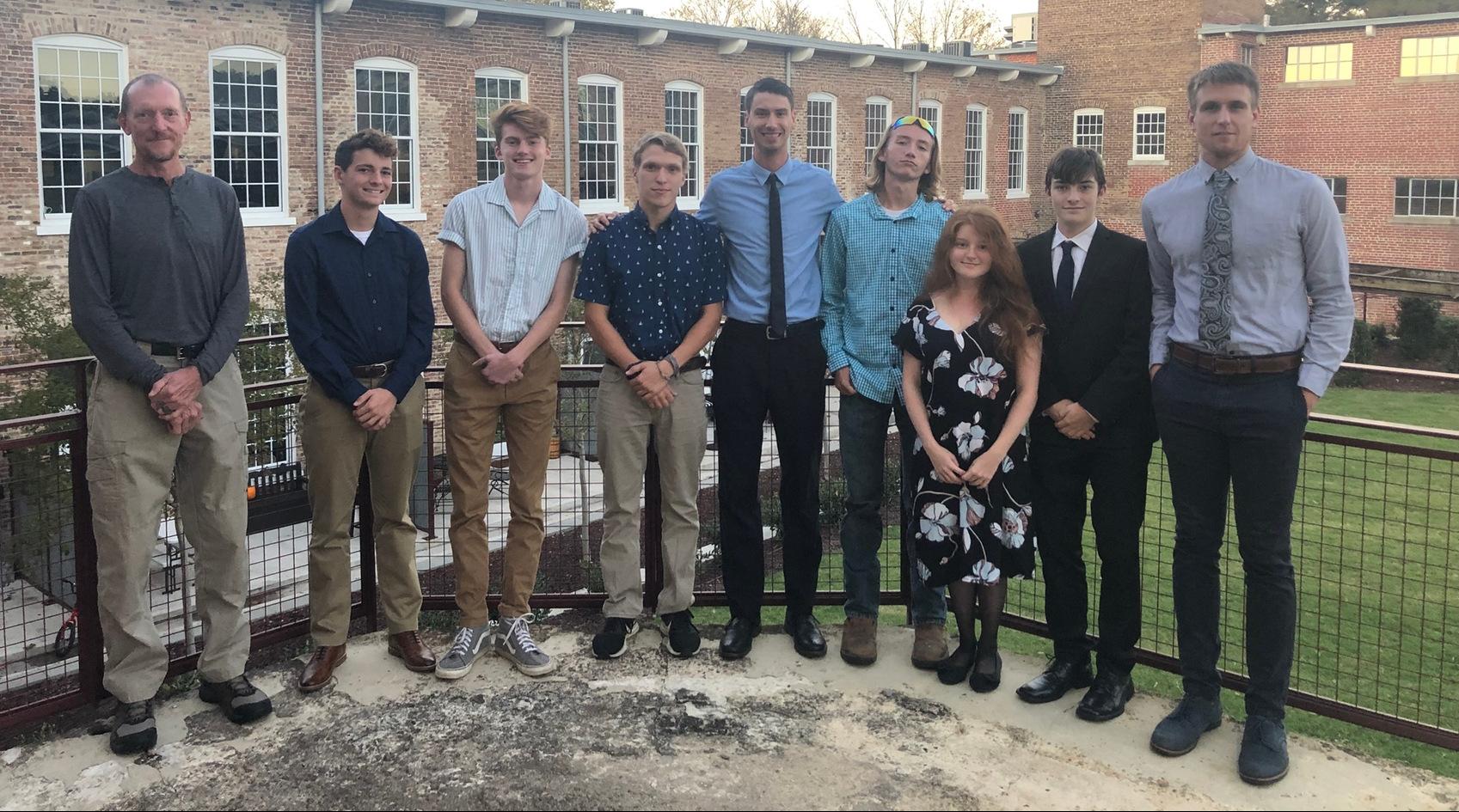 The Brevard College cross country team at the 2019 USA South Cross Country Banquet (Pictured L/R: Volunteer Assistant Coach Chad Newton, Dylan Freeman, Miles Schafer, Solomon Turner, Head Coach Darryll Patrick, Gavin Morgan, Abigail Juul, Michael Fader, & Assistant Coach Jordan Tager)