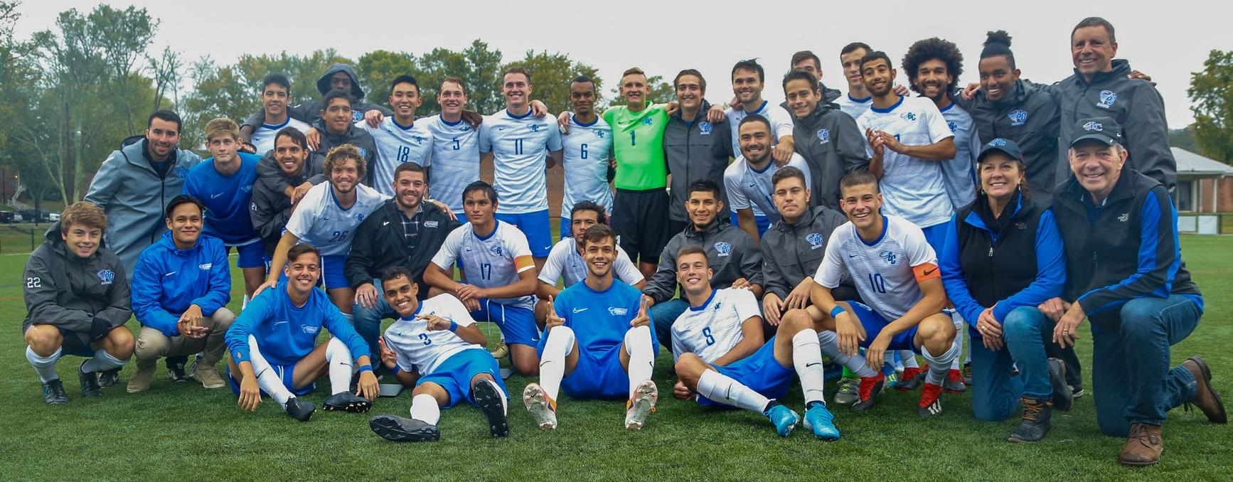 Members of the Brevard College Tornados men's soccer first team and reserve team - along with Head Coach Helio "L" D'Anna, Associate Head Coach Juan Mascaro Jr., Brevard College President David Joyce and First Lady Lynne Joyce - gather around the 10 Brevard College seniors. (Courtesy of Victoria Brayman '22).