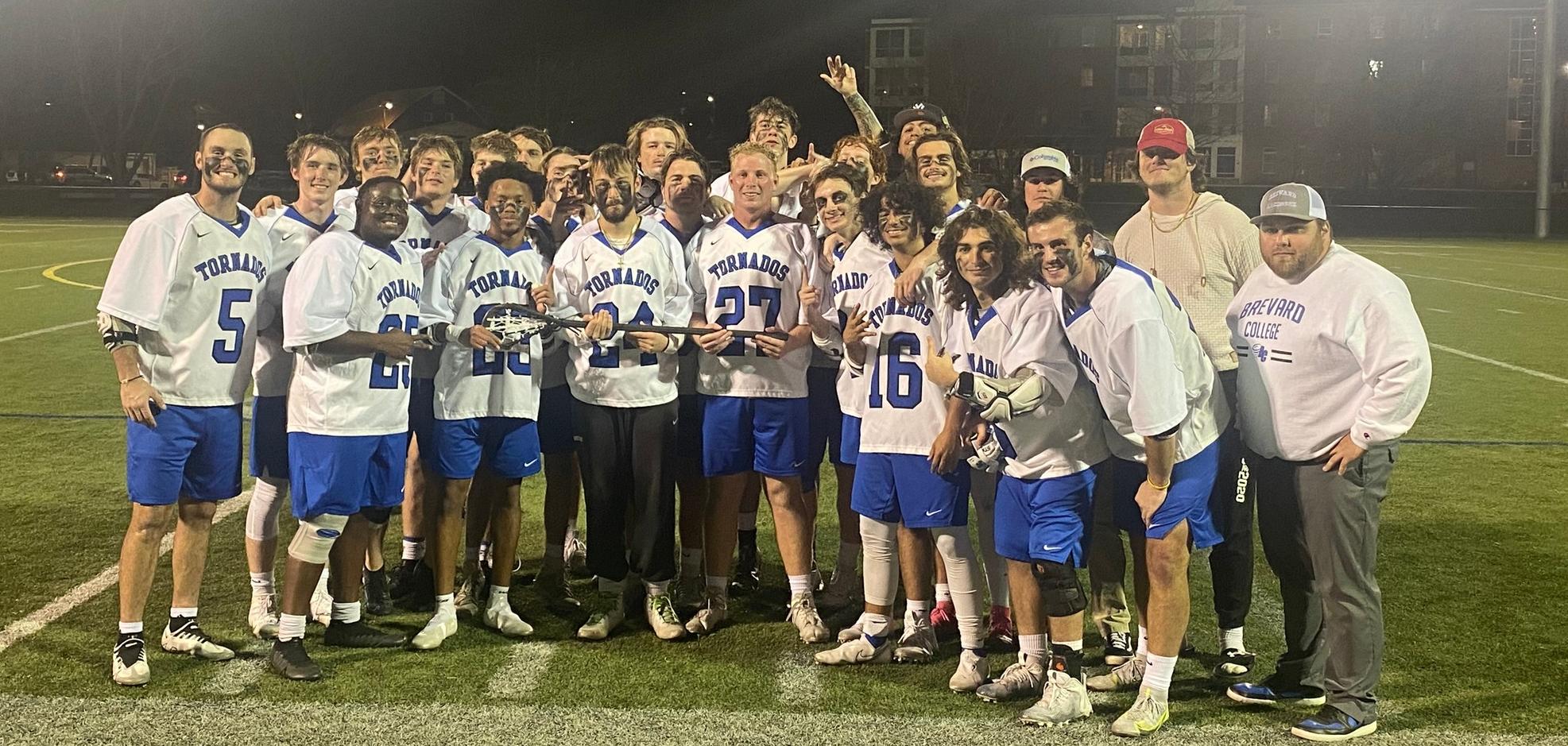 The Brevard College men's lacrosse team gathered with the Blue Ridge trophy following its 17-2 victory over Warren Wilson.